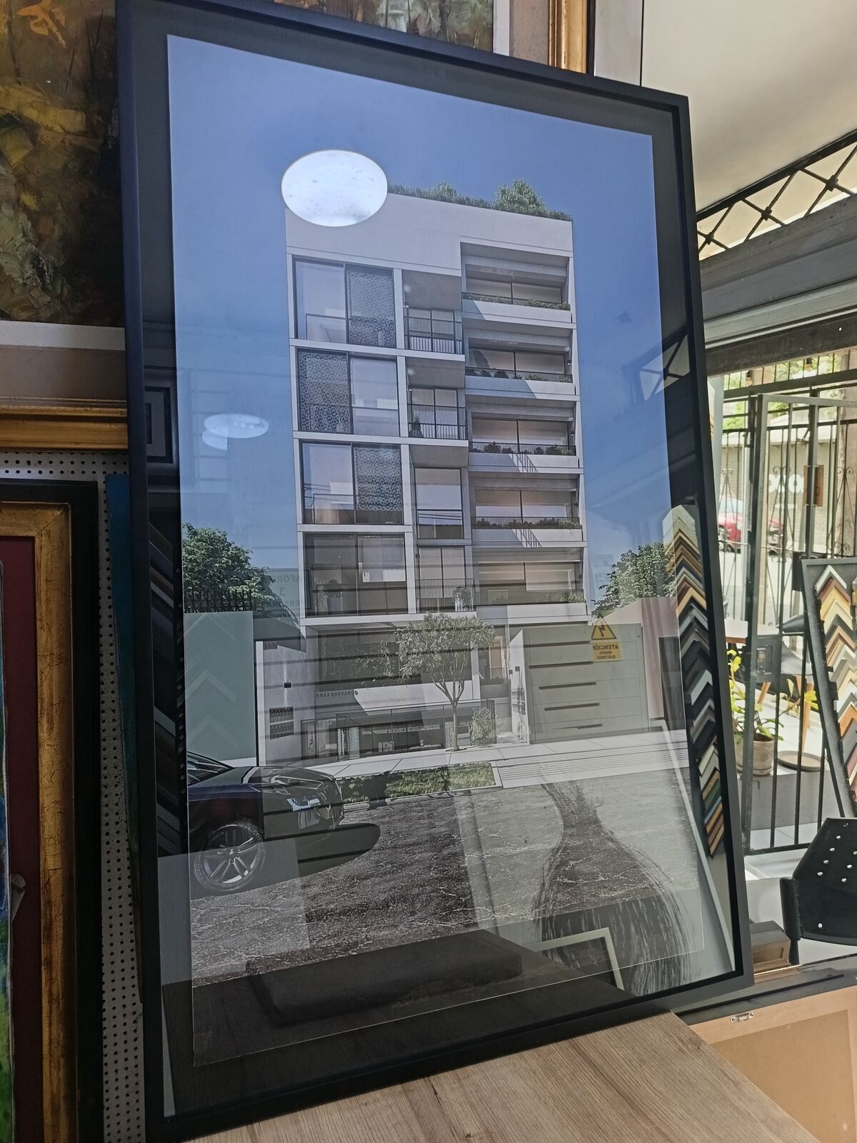 Render arquitectónico enmarcado con vidrio